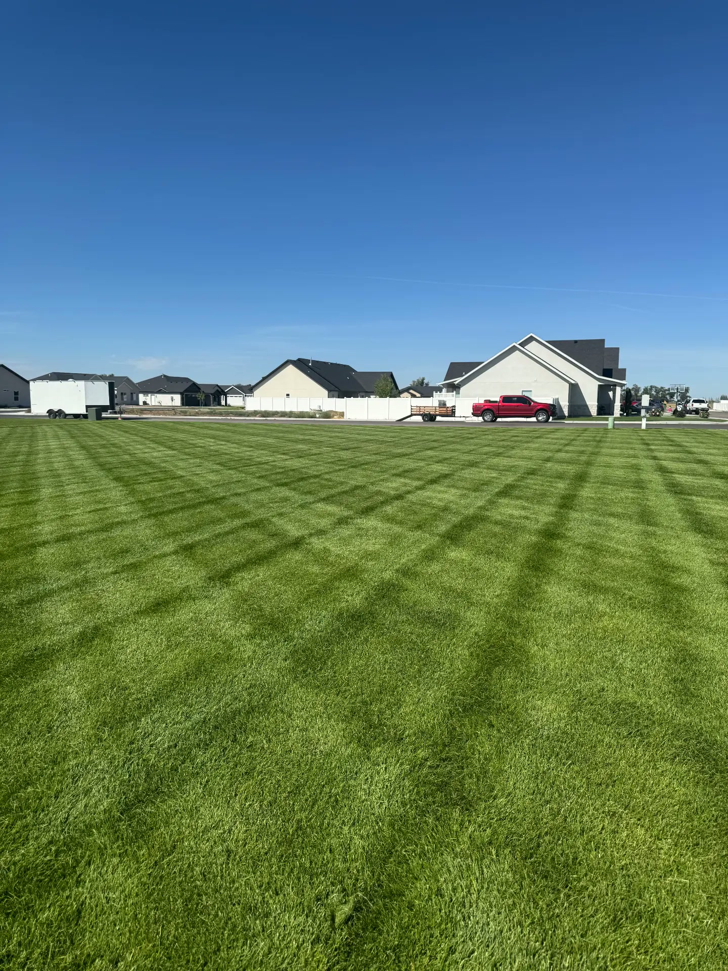 Large lawn freshly mowed in a crisp checkerboard pattern — R & R Lawncare, Burley Idaho