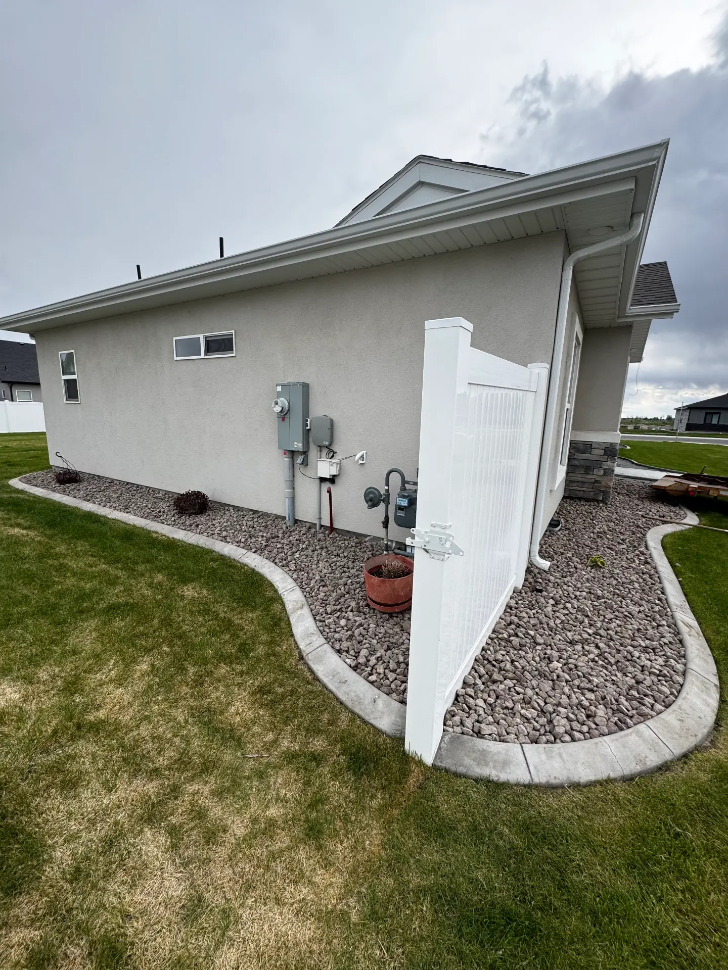 White vinyl fence gate installed along a home — R & R Construction, Burley Idaho